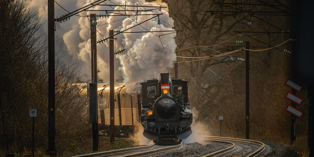 https://unsplash.com/photos/a-train-traveling-down-train-tracks-next-to-a-forest-mW1bD8w8foY